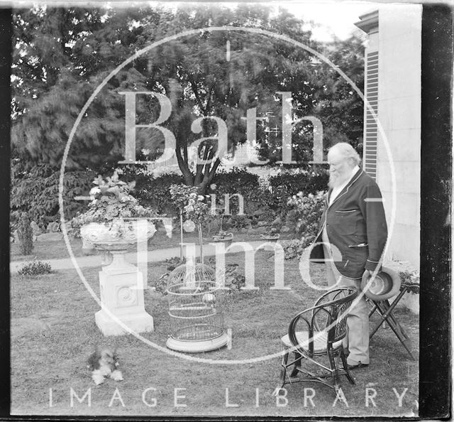 A bearded gentleman in the garden of an unidentified house c.1900