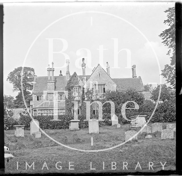 A large unidentified house, possibly a rectory, beside a churchyard c.1890