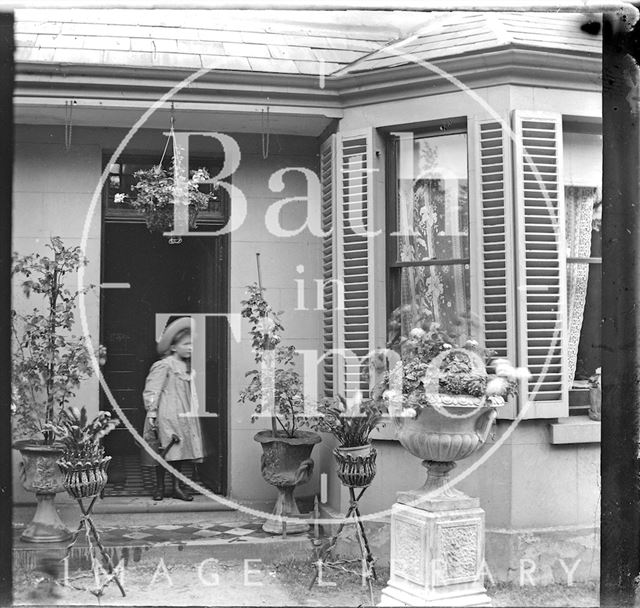 Young girl outside an unidentified house c.1890