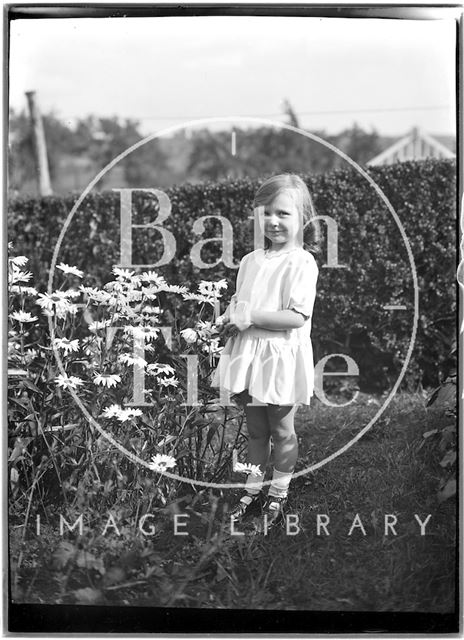 Portrait of a small girl in the garden c.1920