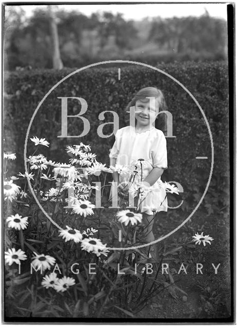 Portrait of a small girl in the garden c.1920