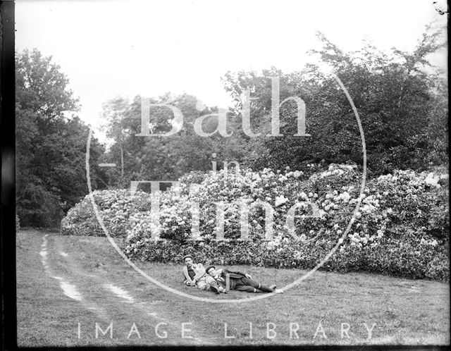 The photographer and a friend lying in the grass c.1890