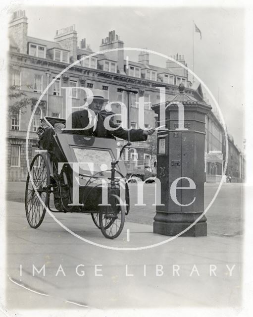 A man in a Bath chair posts a letter at Laura Place, Bath c.1930