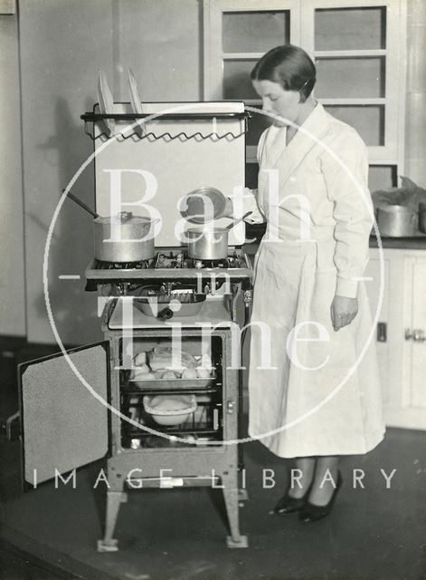 Inspecting a new stove, with a joint and pie about to be baked! c.1930