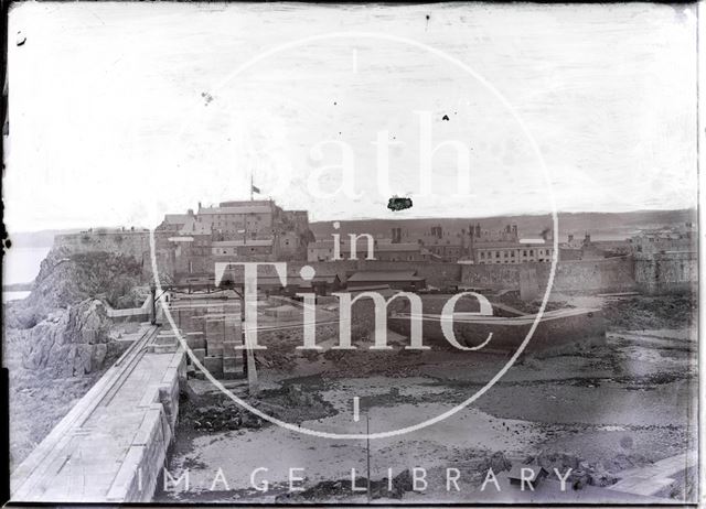 An unidentified coastal village with sea wall c.1902