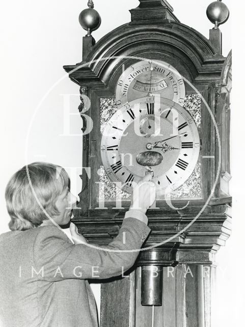 Tompion Clock in Pump Room being wound up by Sam Hunt, Bath Museum curator 1984