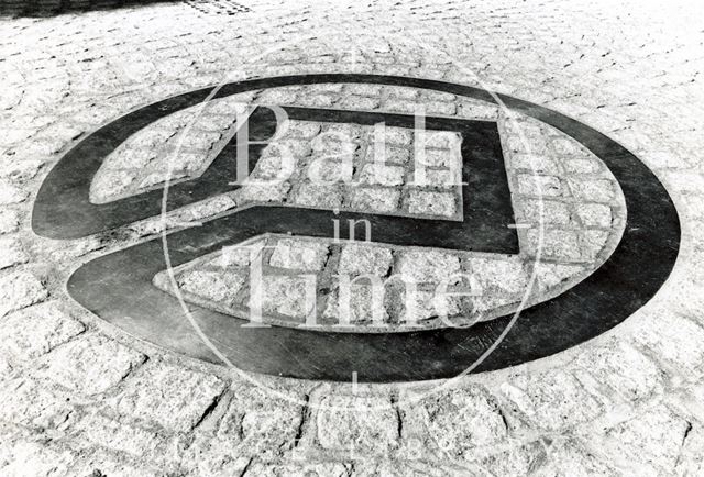 The bronze World Heritage symbol laid in the road, Stall Street, Bath 1988