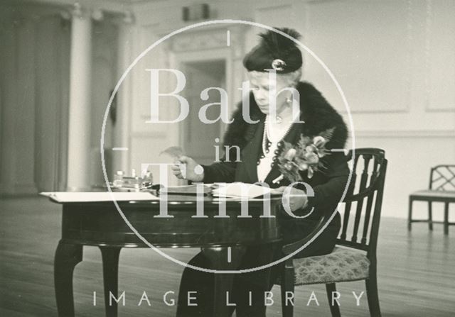 H.M. Queen Mary signing the visitors book, Assembly Rooms, Bath 1938