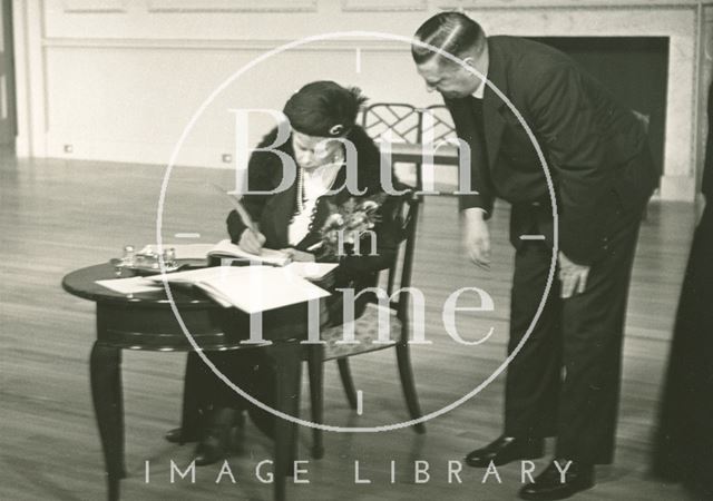 H.M. Queen Mary signing the visitors book, Assembly Rooms, Bath 1938