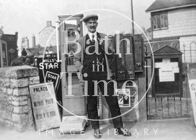 A gentleman in front of stamp machines and the Radstock West signal box, Somerset c.1900