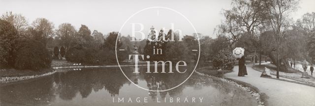 A lady with parasol promenading by the lake at Royal Victoria Park, Bath c.1901