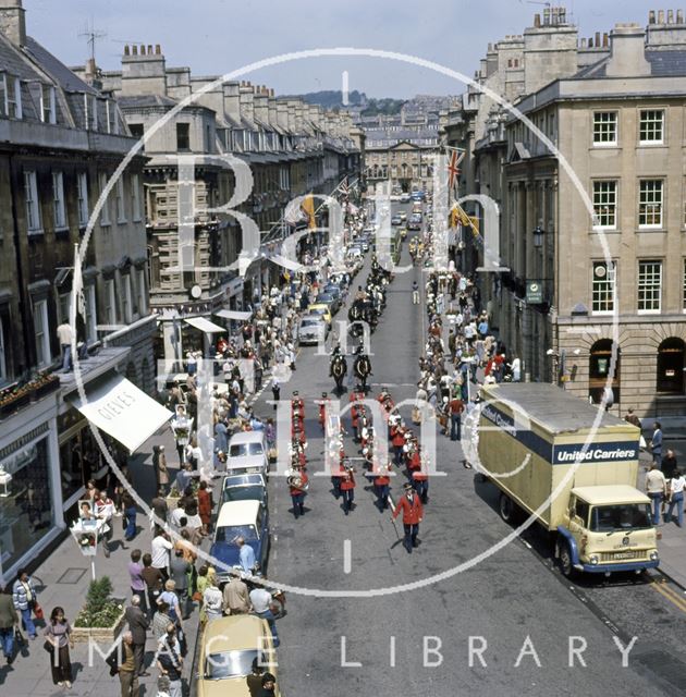 A procession down Milsom Street, Bath led by a panda car 1977