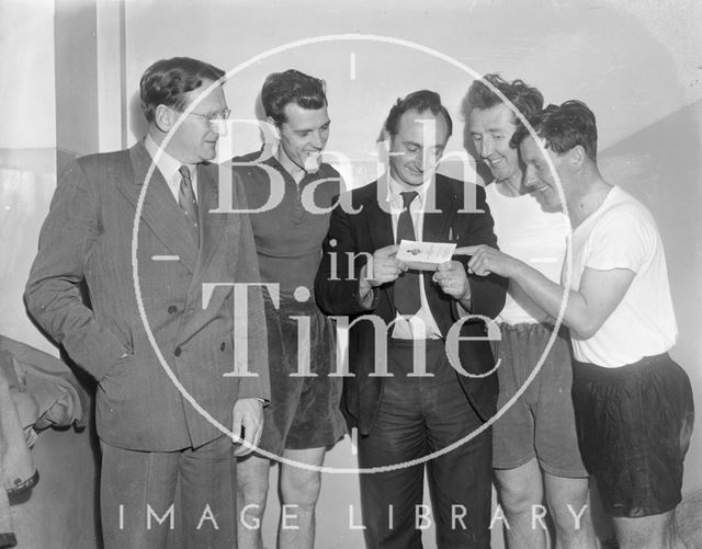 Four members from Bath City football club inspecting a Civil Service document, Bath c.1963