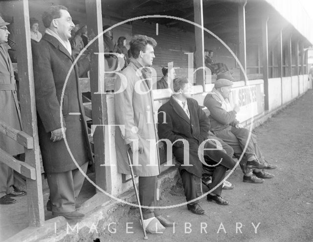 An injured Bath City Football Club star watches the game from the touchline c.1962