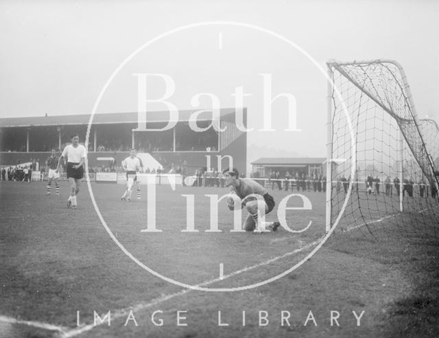 The goalkeeper of the visiting team collects the ball at Twerton Park, Bath c.1963