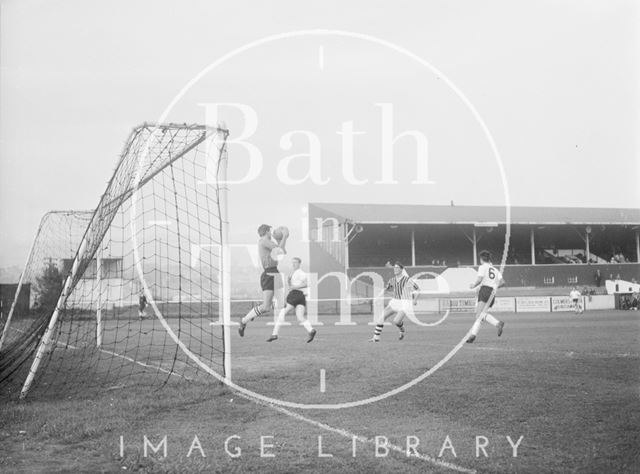 The goalkeeper of the visiting team collects the ball at Twerton Park, Bath c.1963