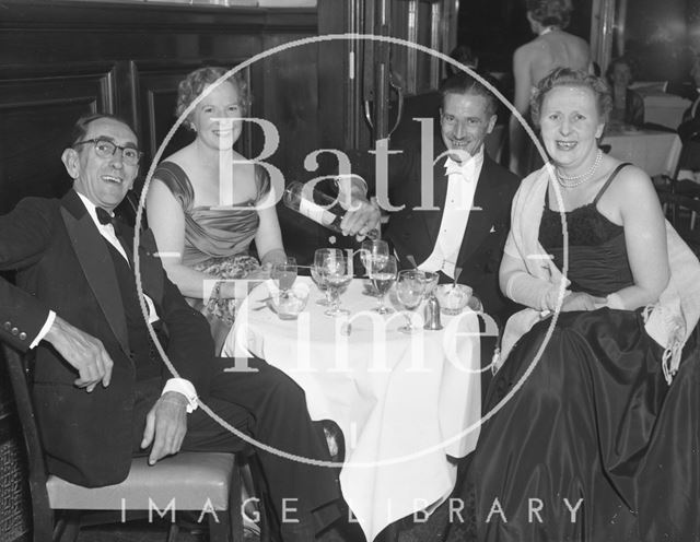 Two couples share a drink at a smart event in Bath c.1963