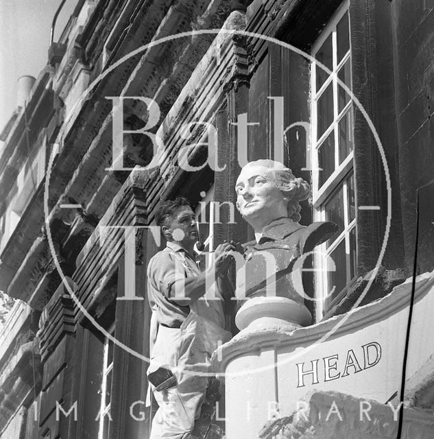 Restoring the stone head of David Garrick above the Garrick's Head, Bath 1970