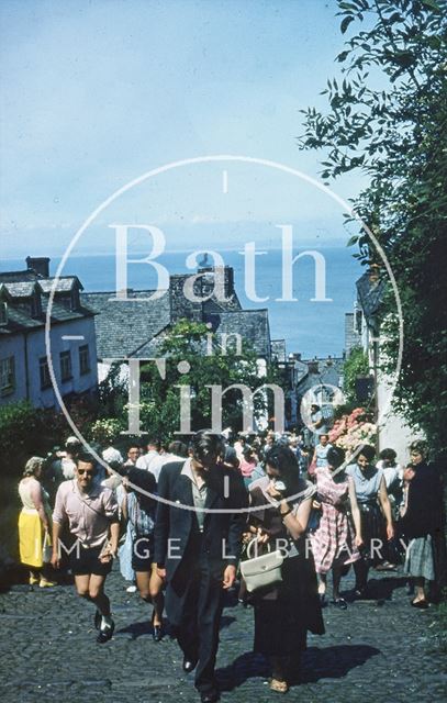 Walking up the cobbles in Clovelly, Devon c.1959