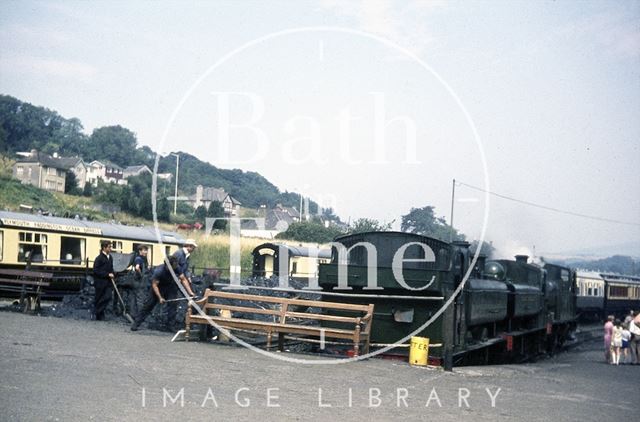 Volunteers shovelling coal for the awaiting steam train, possibly on the South Devon Railway c.1960