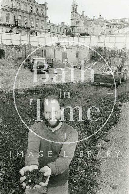 Mark Beaton (Bath Archaeological Trust) holding soil at the Seven Dials construction site, Sawclose, Bath 1990