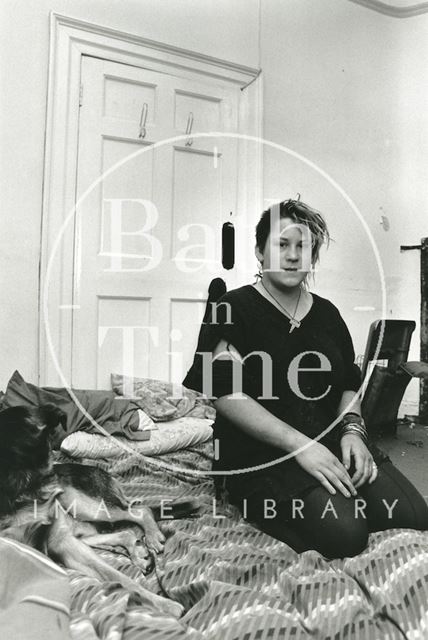 A woman squatting with her dog in the King Edward's Lower School, Broad Street, Bath 1991