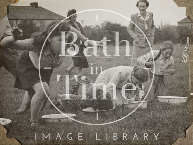 Girls apple bobbing, Charlton Park, Keynsham, Somerset 1945