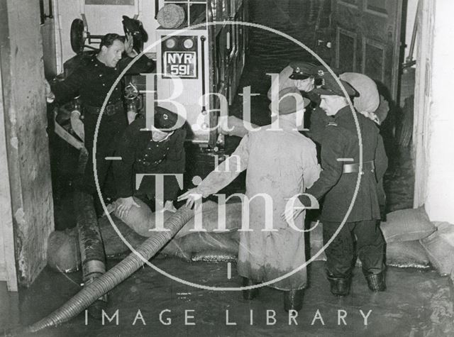 Firemen pumping out a building during the Bath Floods 1960