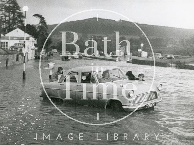 A car attempting to beat the floods at Fiveways, Batheaston 1960