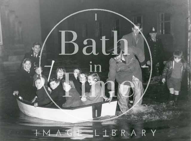 Excited children being evacuated by boat during the Bath Floods of 1960