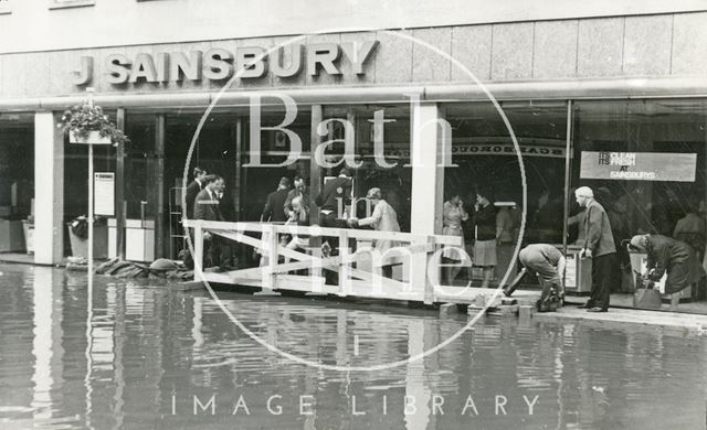 Customers being helped into J. Sainsbury's, Southgate Street, Bath during the floods 1968