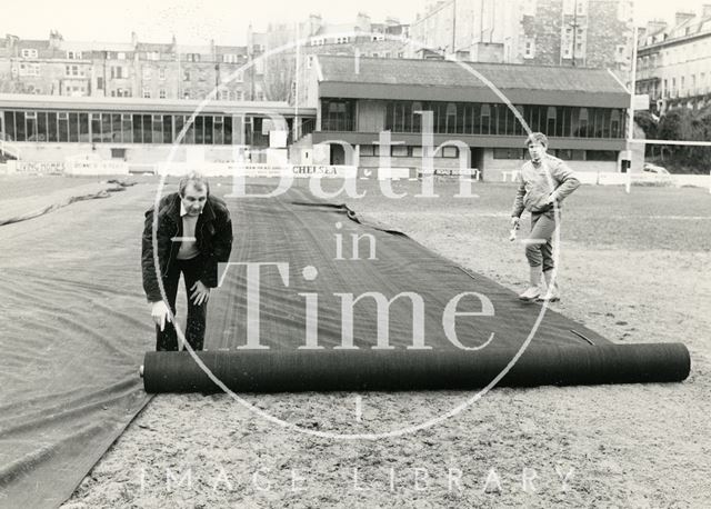 Rolling out protective mesh at the Recreation Ground, Bath 1985