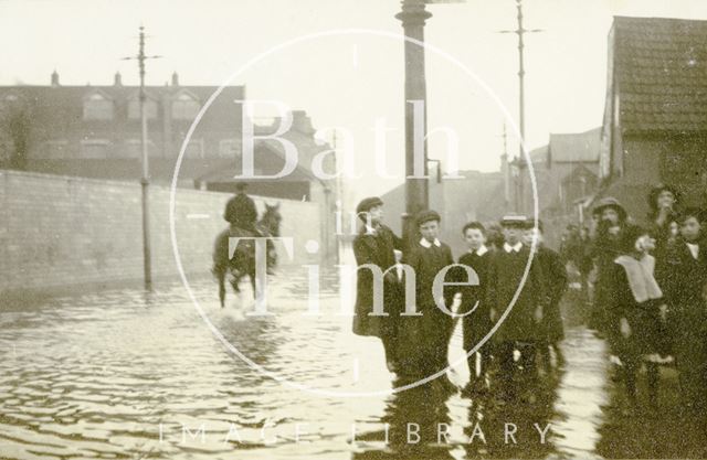 Children on Lower Bristol Road stand beside the flooded road, Bath c.1914