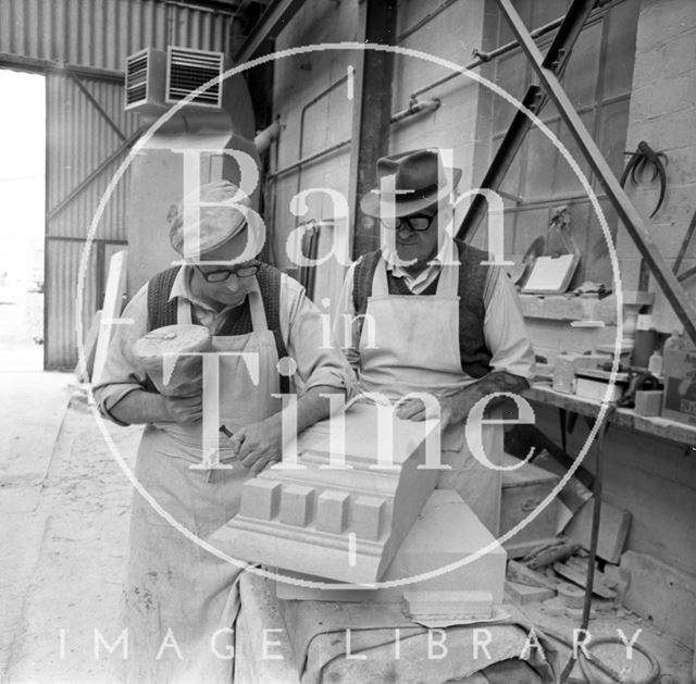 Two stonemasons work on Bath stone at Monks Park Quarry near Corsham, Wiltshire 1973