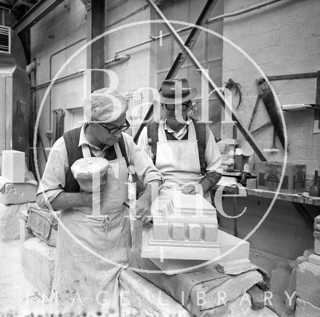 Two stonemasons work on Bath stone at Monks Park Quarry near Corsham, Wiltshire 1973