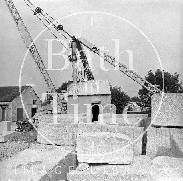 Stacked blocks of Bath Stone and crane at Monks Park Quarry near Corsham, Wiltshire 1973