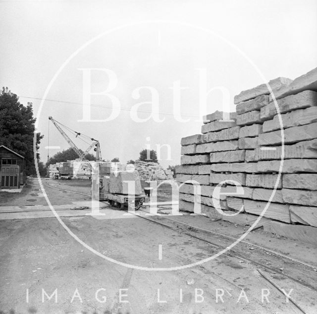 Stacked blocks of Bath Stone and crane at Monks Park Quarry near Corsham, Wiltshire 1973