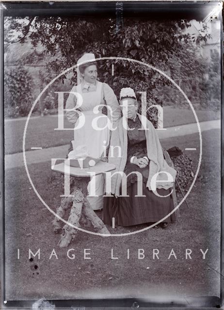 Portrait of two nurses sitting in the garden of Eagle House, Batheaston c.1902